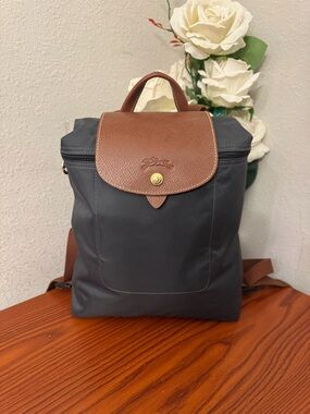 Longchamp navy nylon backpack with brown leather flap and handle